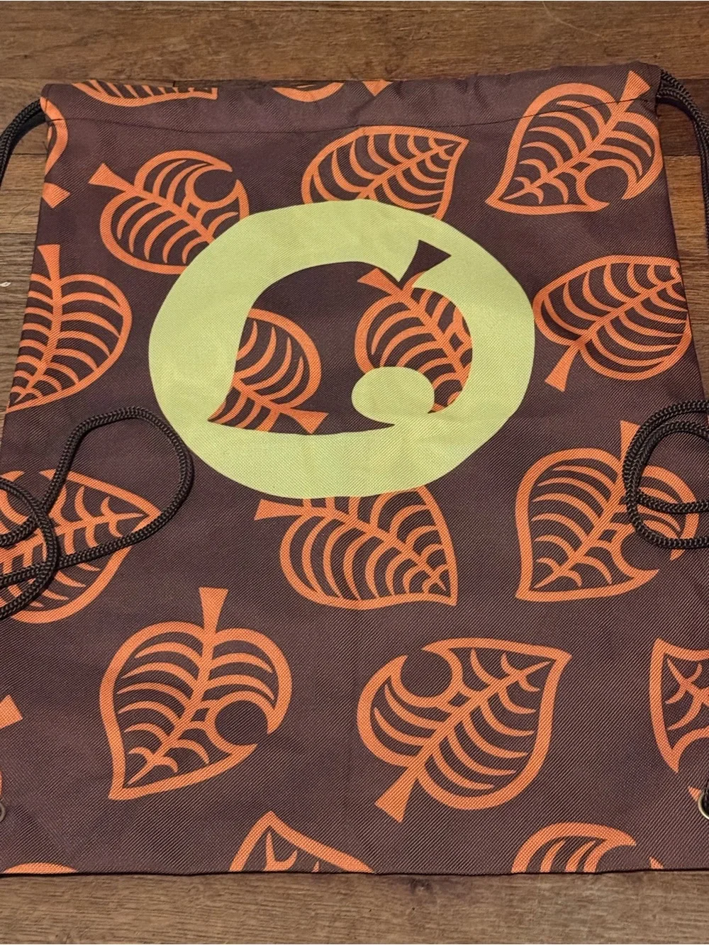 Animal Crossing Drawstring Backpack with Orange Leaf Print and Yellow Badge